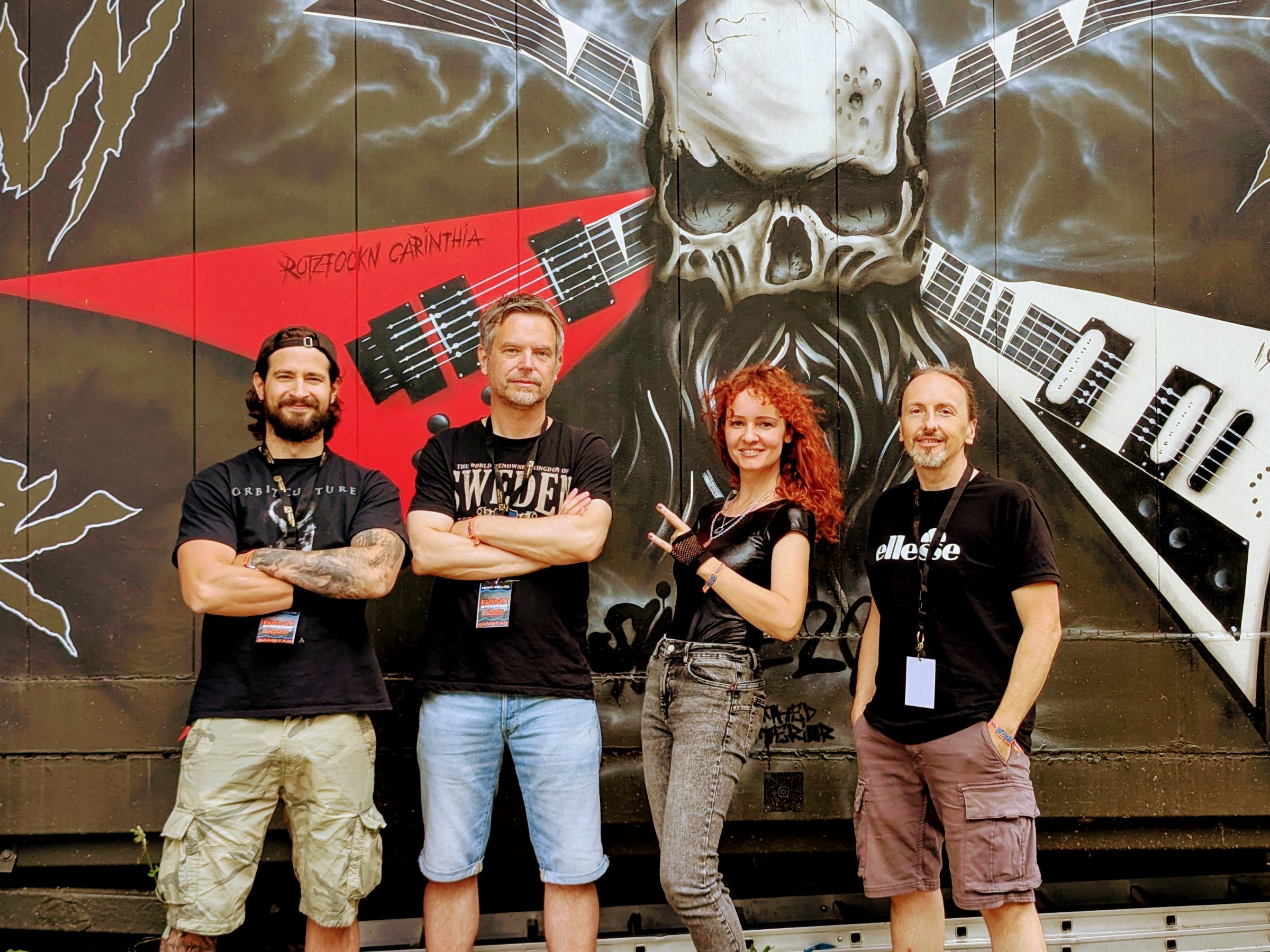 My Dark Fate Band stands before Skull Graffiti